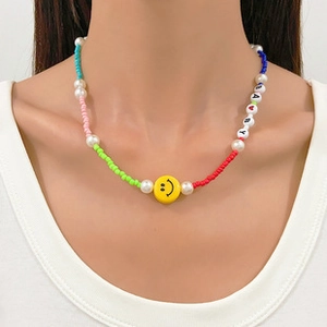Detailed shot of beaded necklace with BABY letters, smiley face and colorful pearls