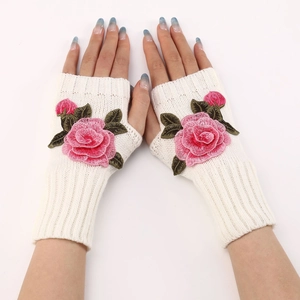 Detail of floral embroidery and knitted texture on fingerless gloves for women