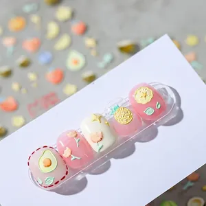 3D embossed nail stickers featuring avocado, pineapple, and tulip patterns in soft pastel tones