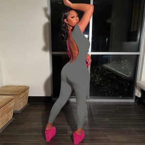 Slim fit backless grey jumpsuit with short sleeves shown from a side-back angle view