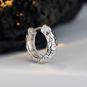 Modern S925 sterling silver hoop earrings with irregular lava texture for women