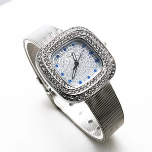 Detail of silver square watch with crystal bezel and metal mesh band on white background
