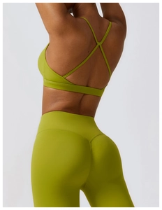 Detailed back view of green yoga bra with cross straps and high waist leggings