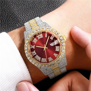 Close-up of luxury men's iced-out watch featuring a red dial and diamond-set gold-tone bezel