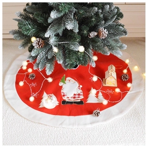 Detail of red Christmas tree skirt with plush white trim and Santa Claus embroidery