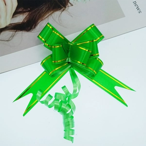 Detail of green gift pull bow with gold edges and satin-like texture on white background