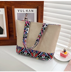 Ethnic canvas tote bag with geometric patterns and beige linen texture in a lifestyle setting