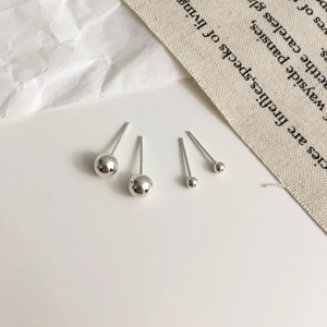 Macro shot of 925 sterling silver ball earrings in large and small sizes with S925 hallmark