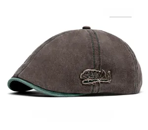 Detail of vintage brown duckbill cap with green contrast brim and side embroidery