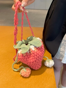 Pink hand-crocheted strawberry bucket bag with green leaf drawstring for girls