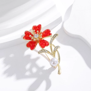 Elegant red flower brooch with gold accents, white pearl, and sparkling rhinestones
