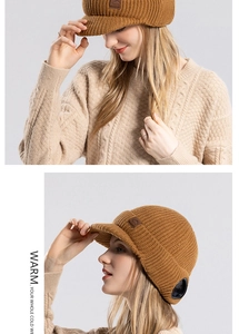 Detailed close-up of a warm mustard yellow knit hat with fleece lining and visor for winter