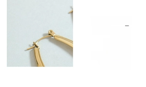 Macro detail of the secure latch closure on minimalist gold U-shaped titanium earrings