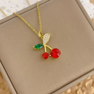 Elegant gold cherry pendant necklace featuring vibrant red and green cubic zirconia stones
