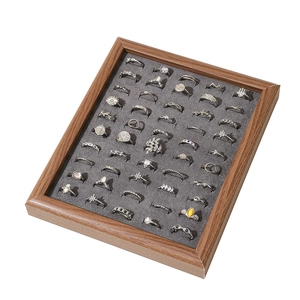 50-slot walnut wood ring display tray with grey velvet lining and assorted jewelry