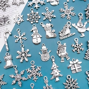 Macro view of vintage silver alloy Christmas pendants featuring snowflakes and Santa motifs