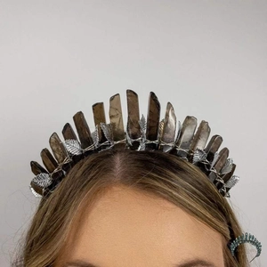 Macro shot of silver bridal crown featuring natural quartz crystals and delicate metal leaves