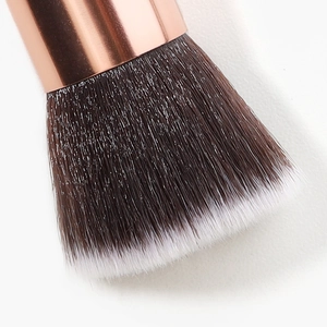 Pink flat top foundation brush with rose gold ferrule and soft dual-color fiber bristles