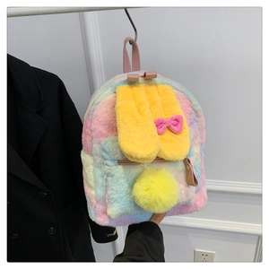 Detail of rainbow plush backpack featuring soft faux fur texture and yellow bunny ears