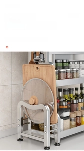 Detail view of stainless steel kitchen rack with integrated cutting board and pot lid holder