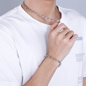 Silver stainless steel box chain necklace and bracelet set shown on model