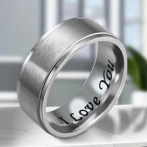 Close-up of brushed silver titanium ring featuring I Love You engraving on the inner band
