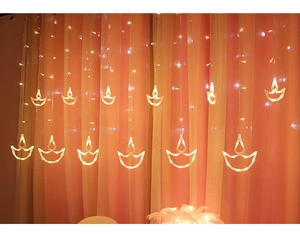 Detail of warm white LED curtain lights featuring traditional Diya shape oil lamp design