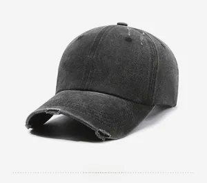 Detail view of washed cotton baseball cap with white FRAGRANCE embroidery and distressed brim