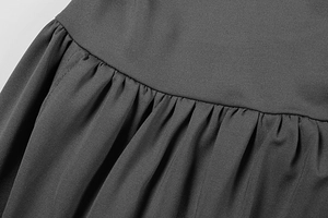 Detailed view of dark grey knitted fabric showing professional ruched texture and stitching