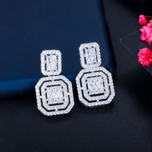 Detailed macro view of geometric S925 silver stud earrings with sparkling cubic zirconia