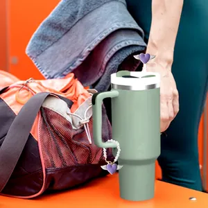 Mint green insulated tumbler with purple heart straw cover and matching handle charm