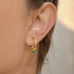 Boucles d'oreilles créoles dorées en acier avec trois anneaux et zircon vert