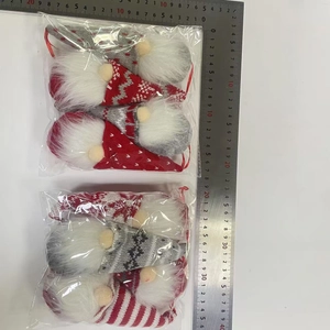 Detail view of 4-piece knit Christmas gnomes with size scale in red and gray tones