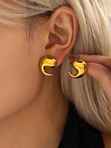 Close-up of polished 18K gold plated stainless steel curved teardrop earrings on ear