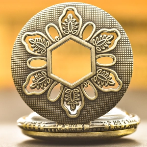 Detailed close-up of retro bronze alloy pocket watch cover with hollow floral embossing