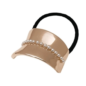Elegant gold metal hair tie with pearl accents on black elastic band for low ponytail