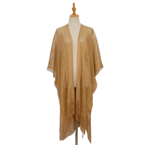 Detail of gold metallic knit shawl showing delicate fringes and sparkling mesh texture