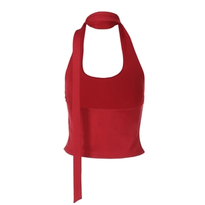 Detail view of red halter neck top with long decorative ribbons on white background