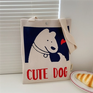 Detail of knitted tote bag showing blue puppy pattern and cute dog embroidery text