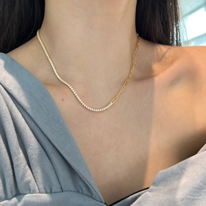 Detail of mixed-link necklace featuring pavé crystal tennis chain and gold paperclip links