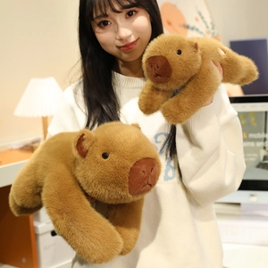 Cute brown capybara plush toys in two sizes shown in a cozy indoor setting