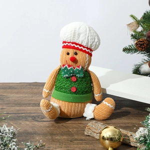 Close-up of a knitted gingerbread man chef candy jar on a festive wooden surface