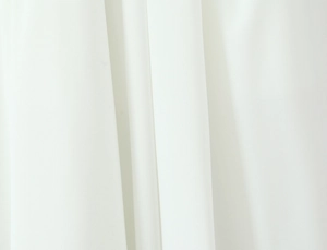 Detailed macro view of white backless dress fabric showing soft draping and texture