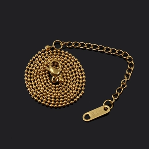 Close-up of 18K gold bead chain necklace with lobster clasp and K18 hallmark detail