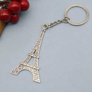 Macro shot of silver Eiffel Tower metal keychain with a polished finish and small chain link