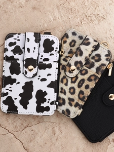 Portable animal print card holder wallets with zipper and snap closure shown on stone background