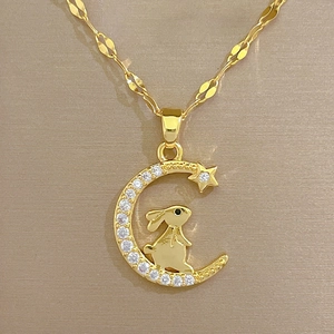 Luxury gold titanium necklace featuring a crescent moon and rabbit pendant with white zircons