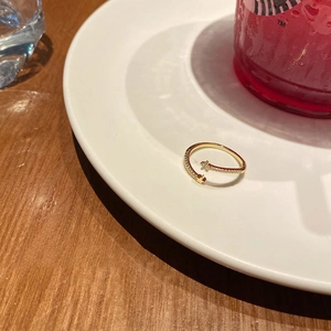 Detailed close-up of a gold open ring featuring sparkling pavé crystal star charms