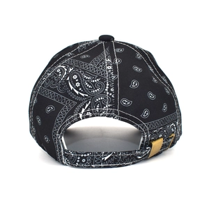 Close-up of black paisley baseball cap back with bronze adjustable metal buckle