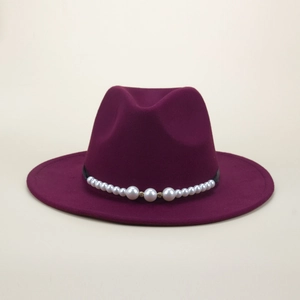 Detail of burgundy wool fedora hat featuring elegant white pearl band and golden beads